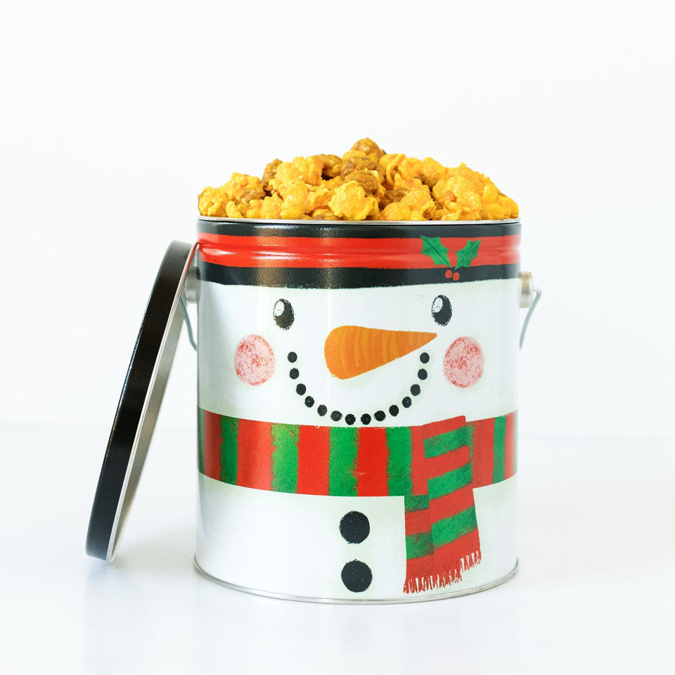 Snowman-themed popcorn bucket with cheddar and caramel popcorn on a white background